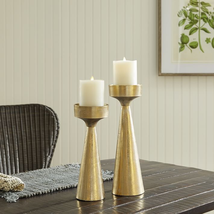 two candles sitting on top of a wooden table