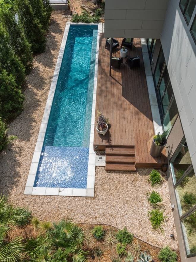 an aerial view of a backyard with a swimming pool