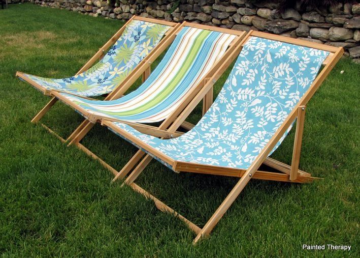 two lawn chairs sitting in the grass