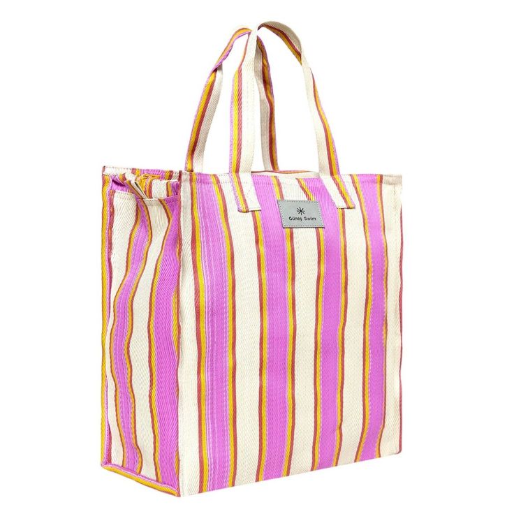 With its bold stripes and spacious, boxy design, this Gunes tote is destined to become your essential summer accessory, whether you're headed to the beach or simply enjoying a city afternoon stroll. made in India recycled nylon zip closure `large - 47cmL x 48cmW medium - 39cmL x 37cmW Summer Rectangular Bag With Striped Lining, Summer Beach Bag With Striped Lining, Travel Bags With Striped Lining, Striped Travel Bags For Summer, Spring Travel Striped Bags, Rectangular Beach Bag With Striped Lining, Rectangular Beach Bag With Striped Lining For Travel, Summer Beach Tote With Striped Lining, Rectangular Vacation Bags With Striped Lining