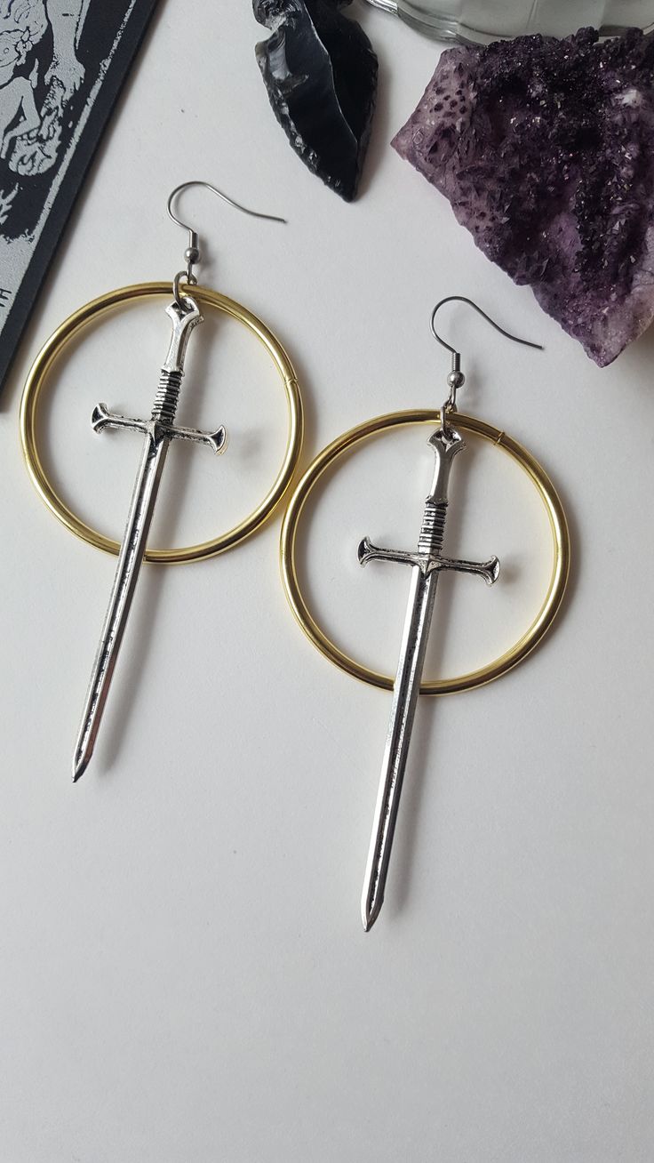 Gold hoops sword earrings Warrior-pagan-LOTR- games of thrones- medieval-witchy-dark aesthetic Hoop Earrings Aesthetic, Gothic Medieval, Earrings Gold Hoops, Earrings Outfit, Aesthetic Earrings, Inner Warrior, Earrings Aesthetic, Big Earrings, Gold Hoops