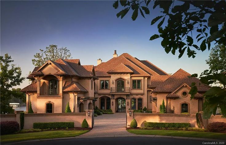 a large house with lots of windows and landscaping