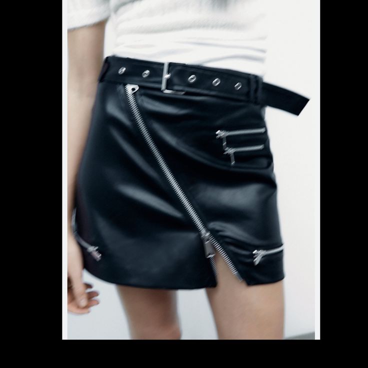 High-Waist Mini Skirt With A Belt In The Same Fabric With Metal Buckle, Zip Appliqus. Edgy Fall Skirt With Zipper Closure, Edgy Mini Skirt With Zipper Closure For Fall, Spring Club Mini Skirt With Zipper Closure, Punk Style Bottoms With Belt For Spring, Punk Style Skirt With Zipper For Night Out, Edgy Mini Skirt With Zipper For Spring, Edgy Belted Spring Bottoms, Black Skirt With Belt Loops For Fall, Edgy Mini Skirt With Zipper Closure For Spring