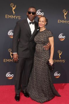 a man and woman posing on the red carpet