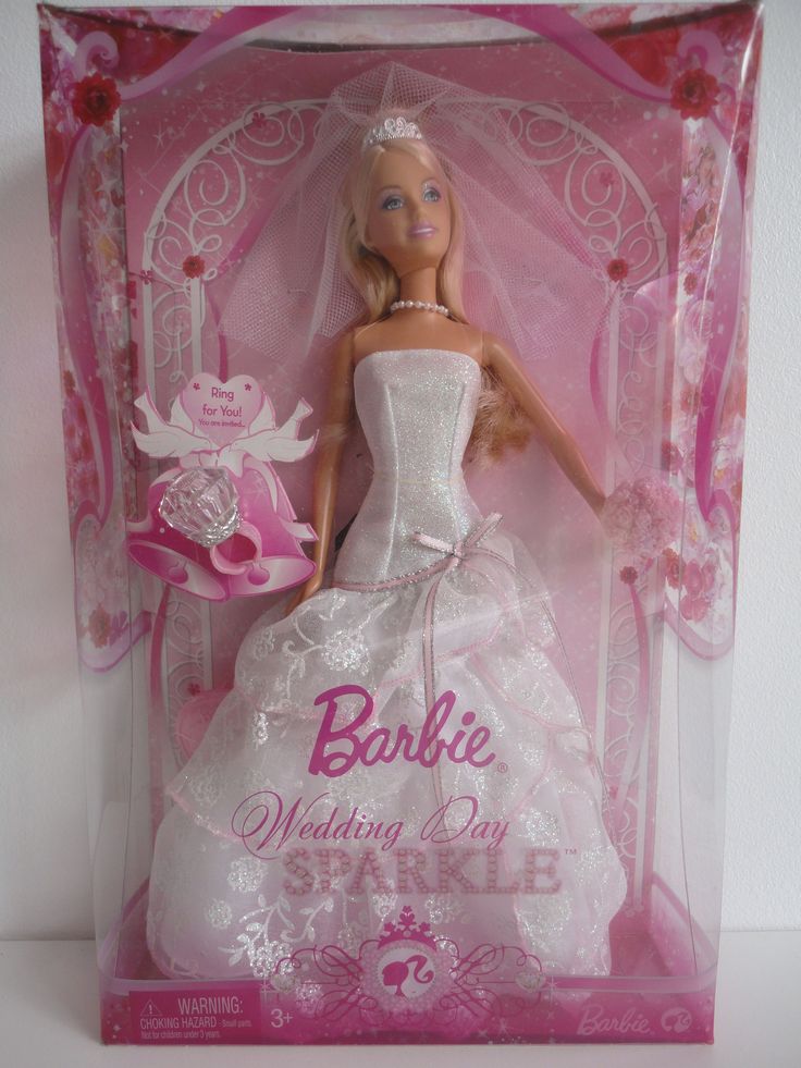 a barbie doll in a wedding dress and tiara with pink ribbon around her neck