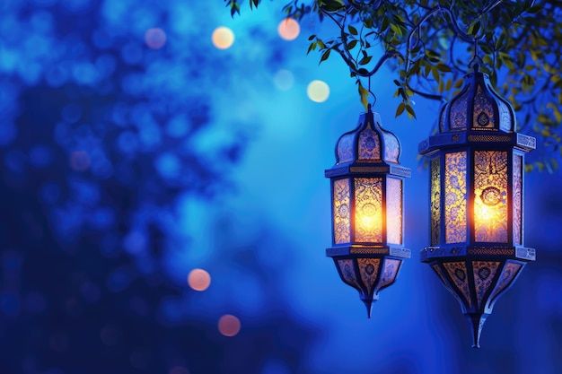 two lanterns hanging from a tree with lights in the background