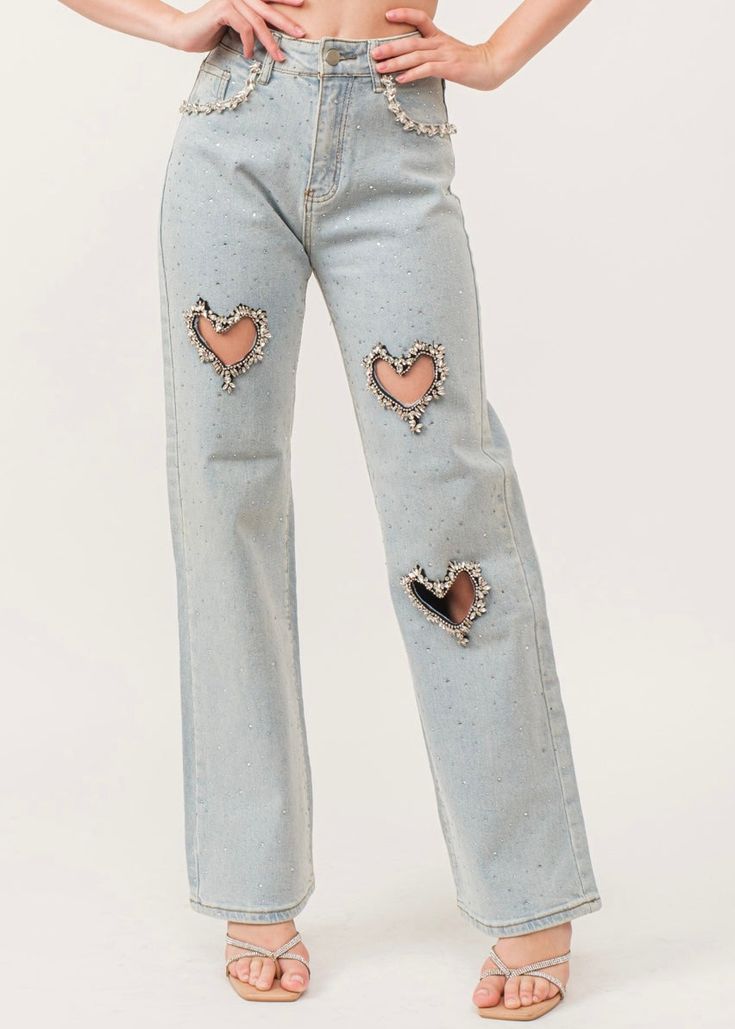 Color: darker blue denim Description: Embellished cutout ieans Stretch denim With Rhinestone-embellished heart cutouts/pocket seams. Hotfix embellishment throughout. Light wash high-rise / Straight leg. Zip fly and button closure. Classic 5-pocket. Material: stretchy Embellished Dark Wash Straight Leg Bottoms, Dark Wash Embellished Straight Leg Bottoms, Embellished Straight Leg Dark Wash Bottoms, Embellished Dark Wash Bottoms, Denim Blue Straight Leg Jeans With Rhinestones, Denim Blue Rhinestone Straight Leg Jeans, Embellished Dark Wash Denim Bottoms, Casual Denim Blue Jeans With Rhinestones, Embellished Denim Blue Straight Leg Jeans