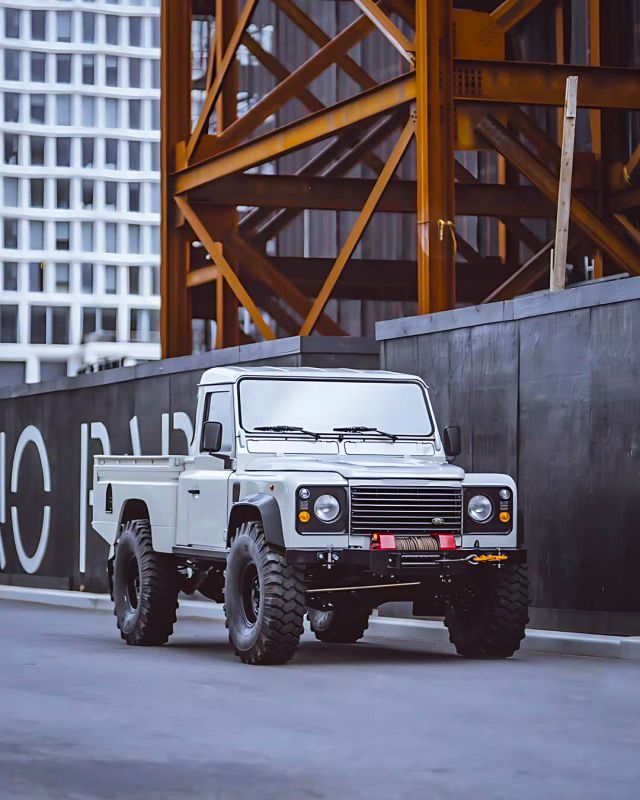 an off - road vehicle is parked on the street