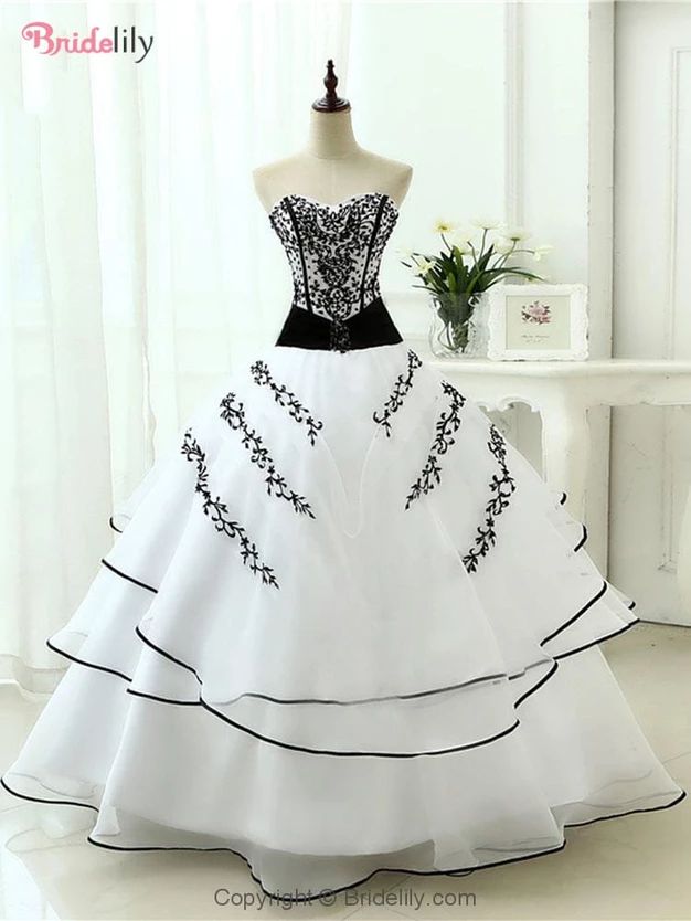 a white and black wedding dress on a mannequin