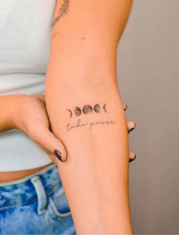 a woman's arm with three phases of the moon on it