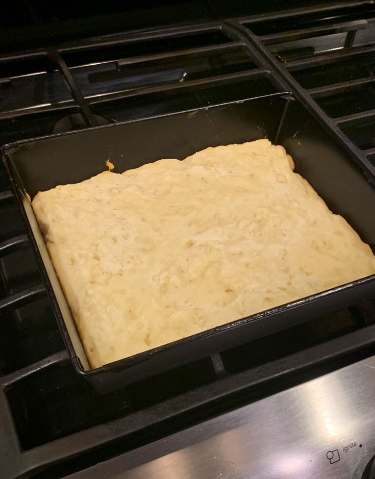 an uncooked pan sitting on top of the stove