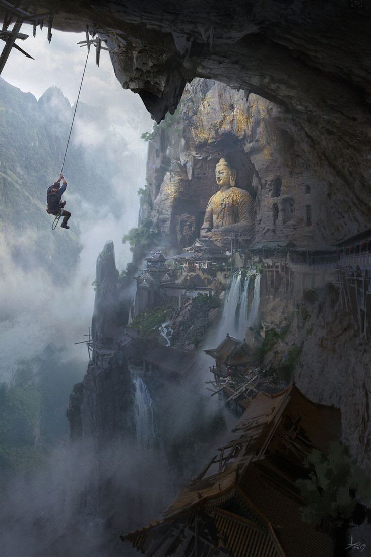 a man hanging from a rope in front of a mountain with a buddha statue on it