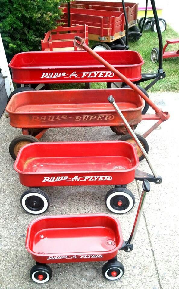 red wagons are lined up on the sidewalk