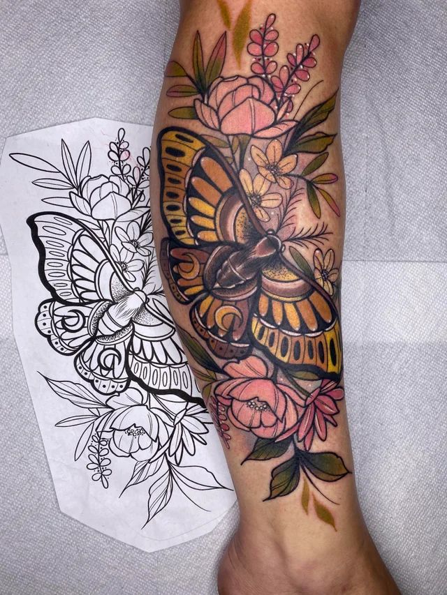 a woman's leg with tattoos and flowers on it