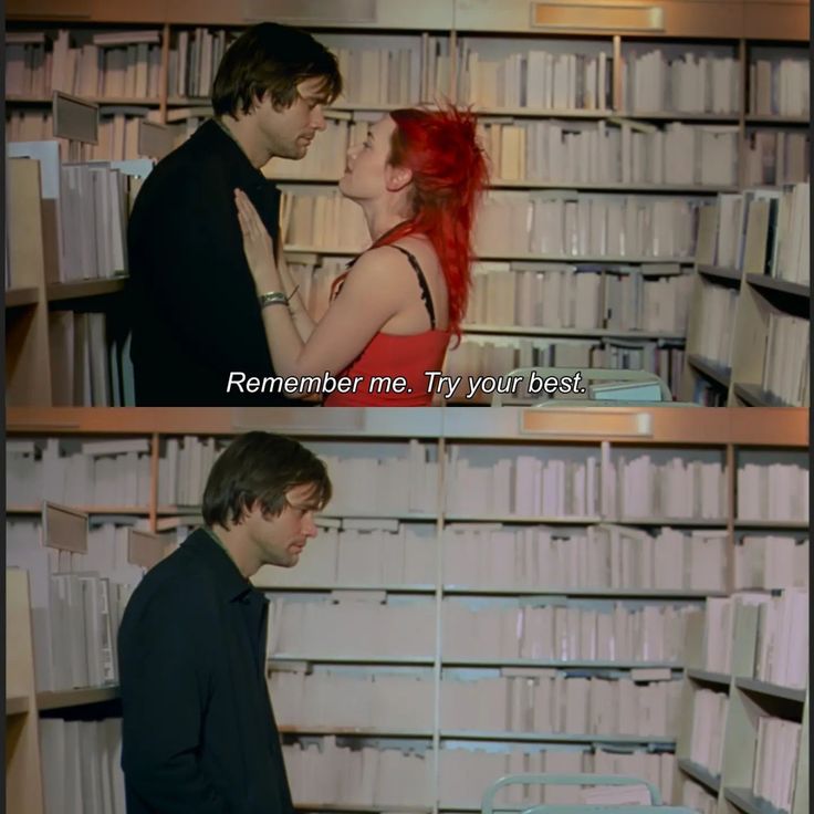 two people standing next to each other in front of bookshelves with words on them