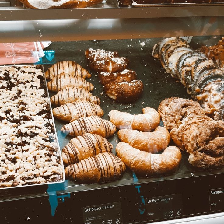 a display case filled with lots of different types of doughnuts and pastries