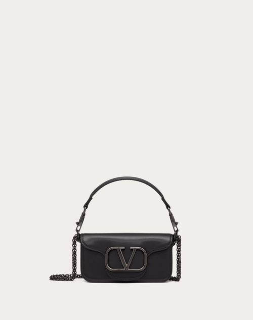 Valentino Garavani Locò small shoulder bag in calfskin with metallic VLogo Signature detail. Equipped with both a detachable sliding chain strap and a detachable handle, this accessory can be worn as a crossbody/shoulder bag or carried as a handbag. - Tone-on-tone-finish hardware - Magnetic closure - Removable leather handle - Shoulder strap with removable sliding chain - Nappa leather lining. Interior: one slip pocket - Shoulder strap drop length: 55 cm / 21.7 in. - Dimensions: W20xH11xD5 cm / Valentino Bag, Bow Mules, Studded Sneakers, Oxford Boots, Boot Accessories, Small Shoulder Bag, Boots For Sale, Bag For Women, Small Leather Goods