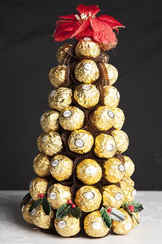 a christmas tree made out of chocolates with a red bow on it's top