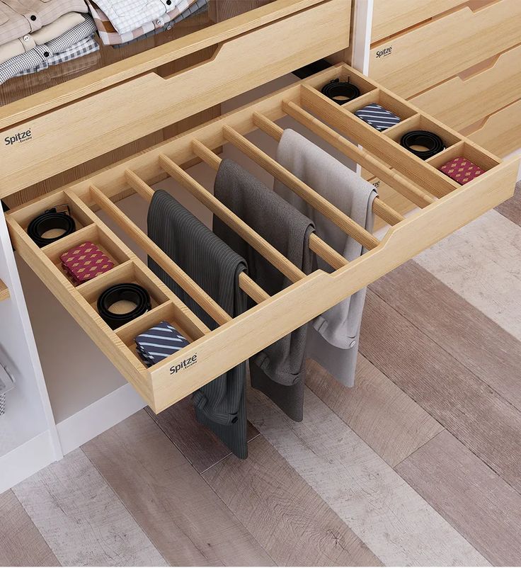 an open drawer with several pairs of shoes in it and the word spitze next to it