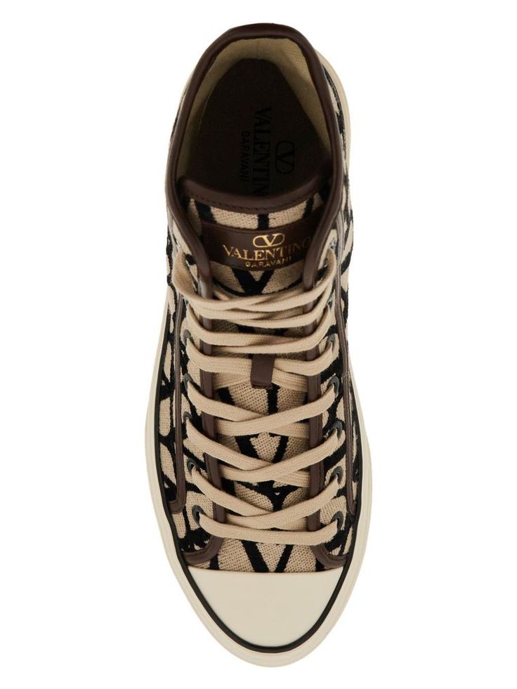 Step up your sneaker game with these high-top sneakers by Valentino Garavani. Made of toile iconographe with leather details and featuring a gold-tone logo print on the tongue, these sneakers are the perfect blend of style and comfort. With a fabric lining, removable insole, and rubber sole featuring an embossed monogram pattern, these high-tops are the ultimate statement piece for any fashion-forward individual. Plus, they come with spare laces for added versatility. Fabric lining Removable ins Hermes Birkin 25, Versace Bags, Monogram Pattern, Birkin 25, Prada Designer, Sneaker Games, Fendi Bags, Casual Backpack, Prada Bag