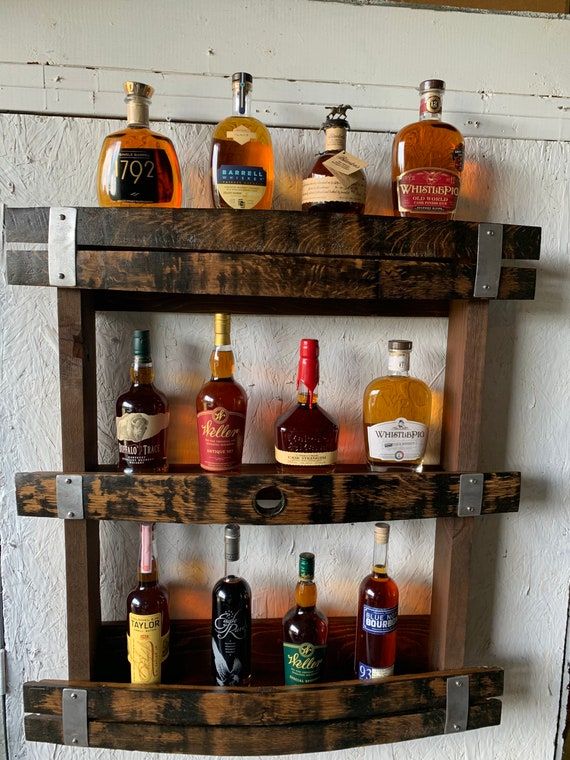 an old wooden shelf with liquor bottles on it