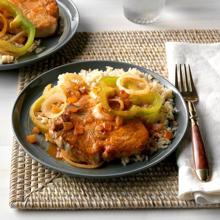 two plates filled with rice, meat and vegetables