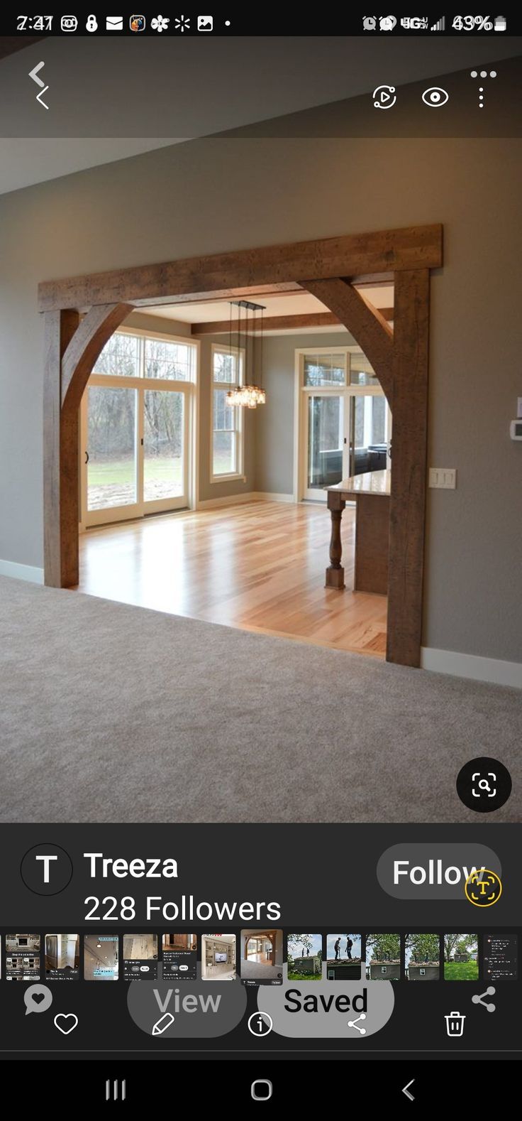 an empty living room with wood beams and windows