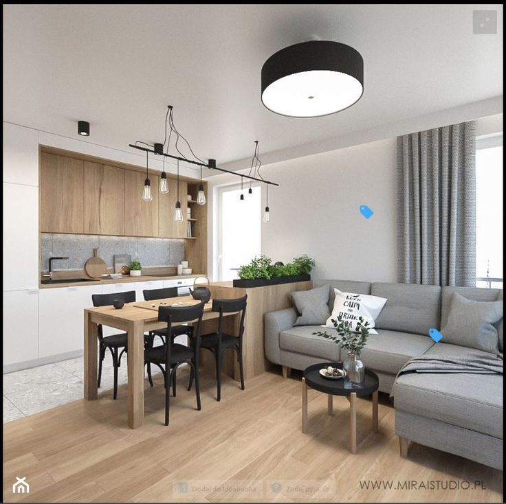 a living room filled with furniture next to a kitchen and dining room table in front of a window