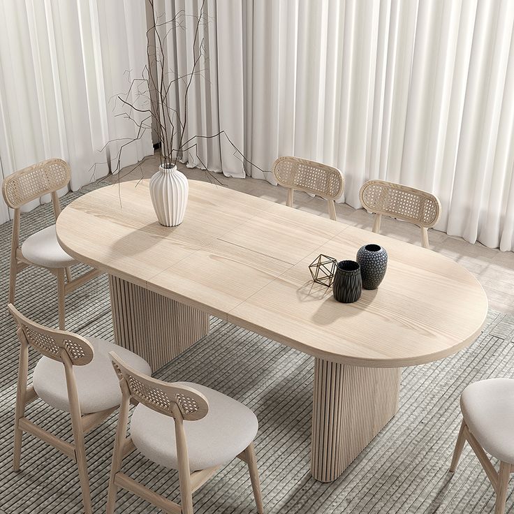 a dining table with chairs around it and a vase on the table next to it