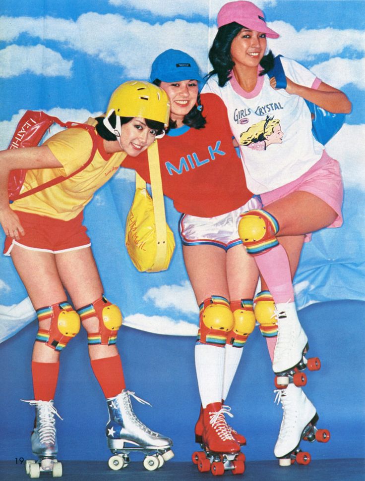 three women in roller skates are posing for the camera