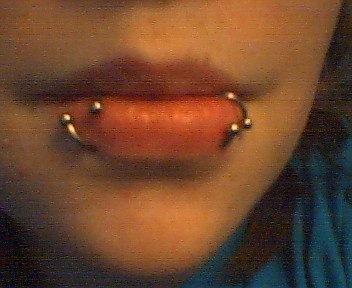 a woman with piercings on her tongue