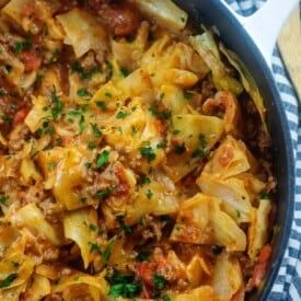 a casserole dish with meat and vegetables in it on a checkered cloth