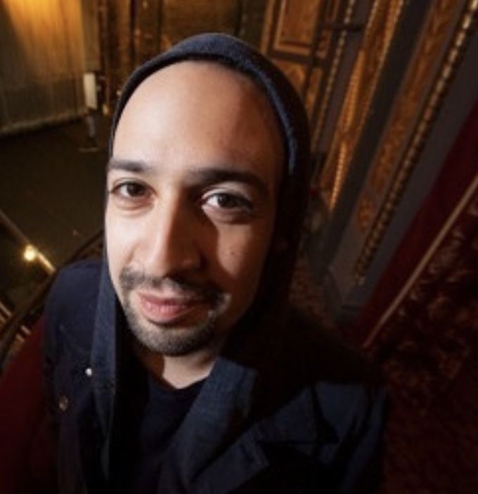 a man with a turban on standing in front of stairs