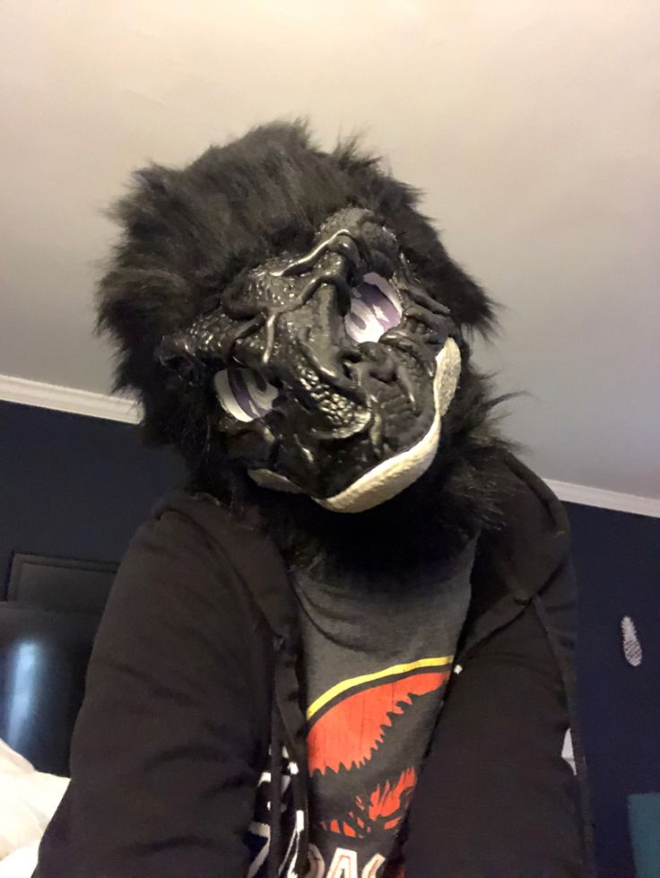 a person wearing a gorilla mask and jacket