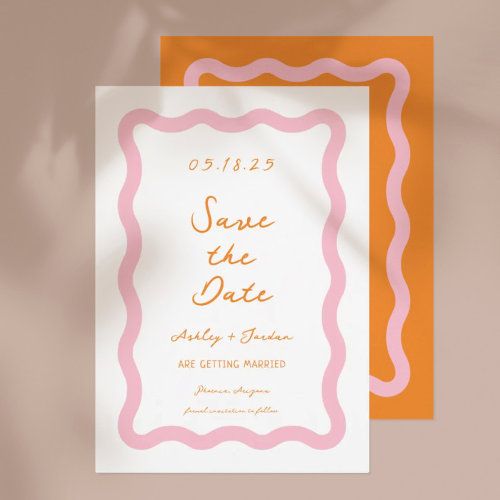 an orange and white save the date card on top of a yellow envelope with a pink border