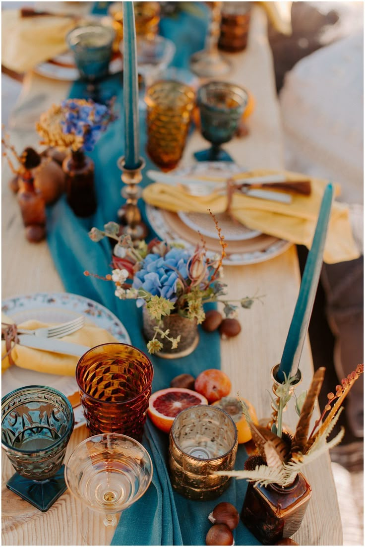 the table is set with dishes and candles