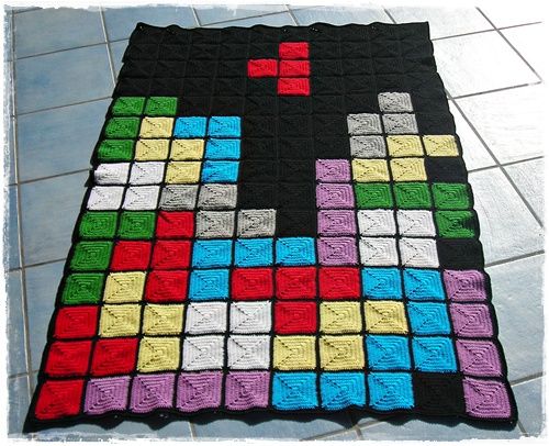 a blanket made to look like an old school computer game controller with colored blocks on it