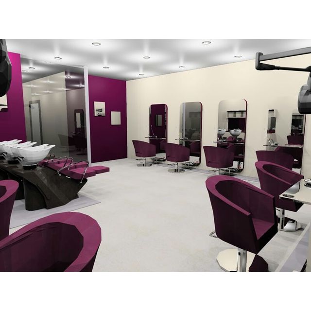 the interior of a hair salon with purple chairs