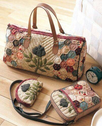 a handbag and purse sitting on top of a wooden table next to an alarm clock