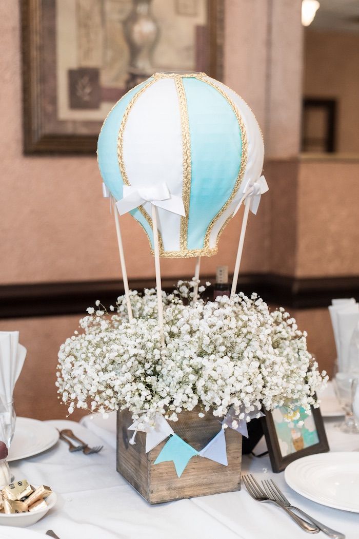 a hot air balloon centerpiece with baby's breath