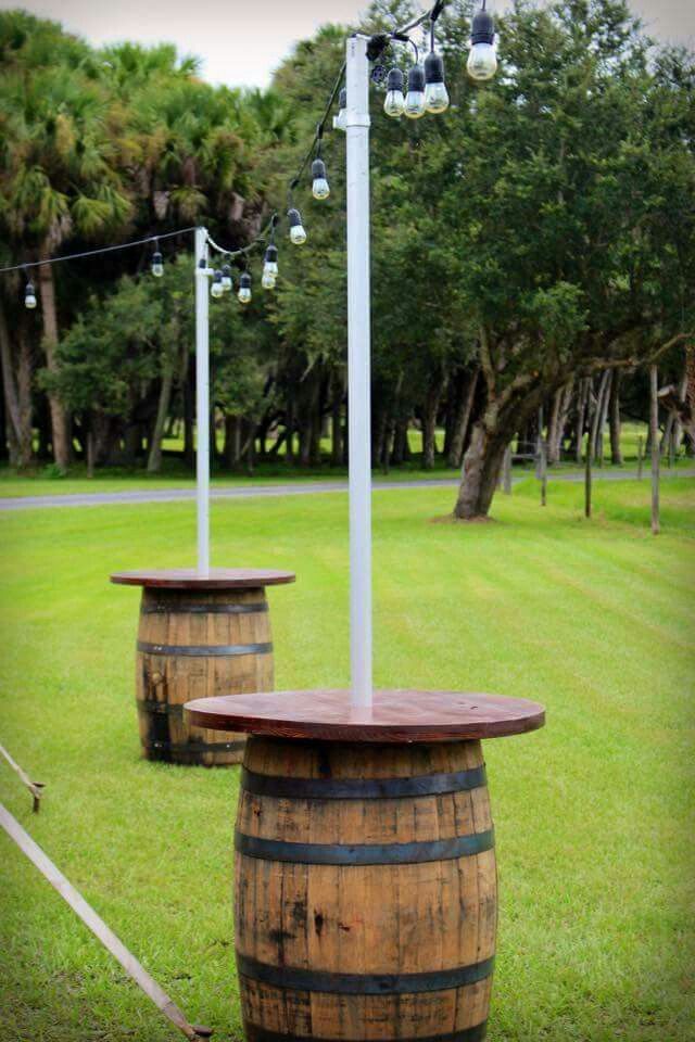 two wooden barrels sitting on top of grass next to a street light and lamp post