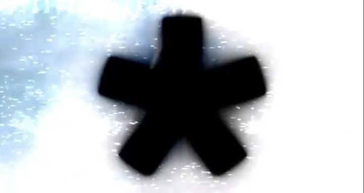 a blurry image of a black cross on a white background