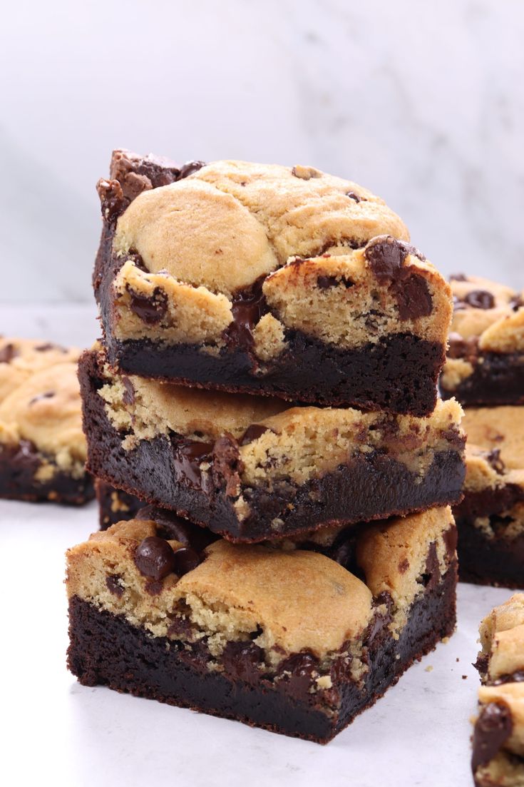 a stack of chocolate chip cookie brownies sitting on top of a white countertop