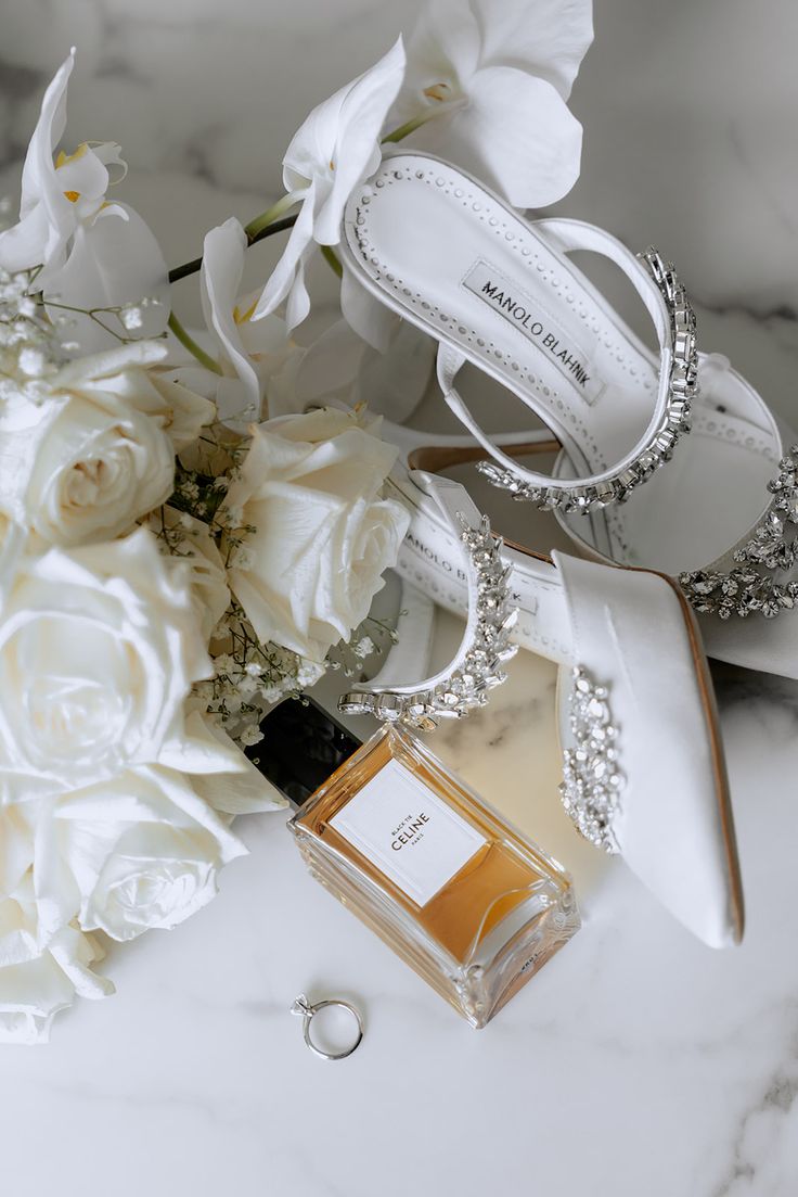 a bouquet of white flowers sitting next to a pair of shoes