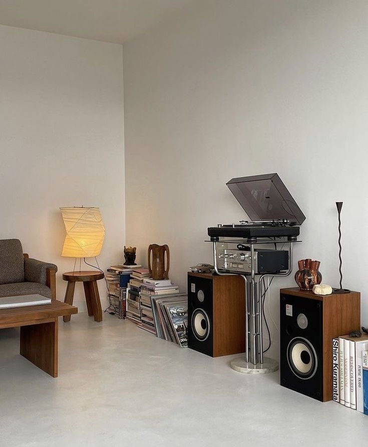 a living room filled with furniture and sound equipment