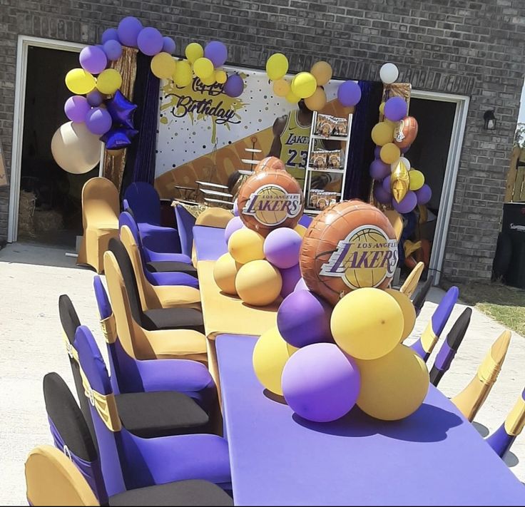 a table with balloons and basketballs on it