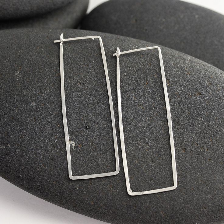 "These silver and 14K white gold rectangle hoops have been hand formed and hammered for strength and a subtle texture that sparkles. The posts tuck into a loop catch on the backside of the earring, so there's no risk of losing backs. Modern, elegant, feminine and bold, these earrings are always in style and will always match. This particular pair of earrings from the line is a long rectangle - 1 7/8 inches long and about 5/8\" wide. Made from responsible and recycled metals - sterling silver and Modern Hypoallergenic Rectangular Jewelry, Everyday Hammered Rectangular Jewelry, Hammered Rectangular Sterling Silver Jewelry, Rectangular Hammered Sterling Silver Jewelry, Minimalist Rectangular Hypoallergenic Hoop Earrings, Hammered Sterling Silver Jewelry In Rectangular Shape, Modern Rectangular Metal Hoop Earrings, Minimalist Hypoallergenic Rectangular Hoop Earrings, Classic Sterling Silver Rectangular Earrings