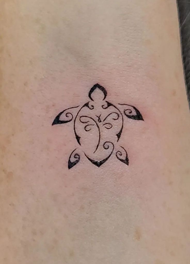 a small turtle tattoo on the ankle