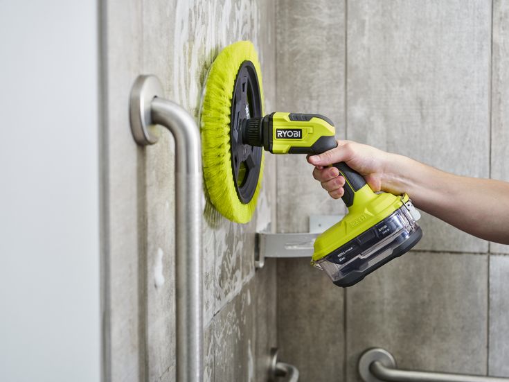 a person using a power tool on a wall