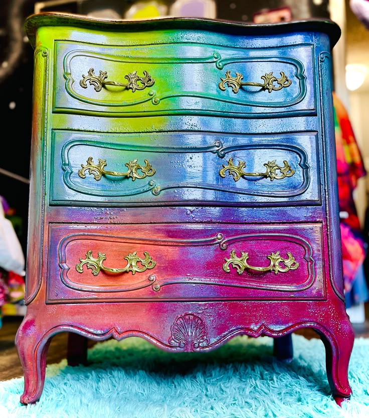 a multicolored dresser sitting on top of a blue rug